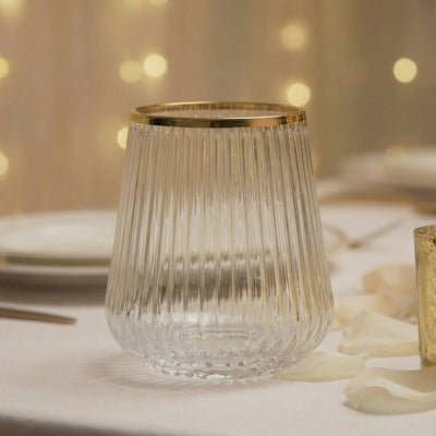 Gold-rimmed ribbed glass tumbler on elegant table setting