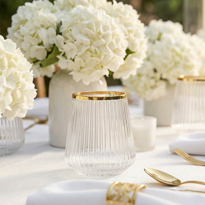 Elegant gold-rimmed glass candle holders with white hydrangea table decor