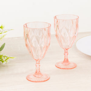 Set of two pink crystal goblets with a diamond pattern.