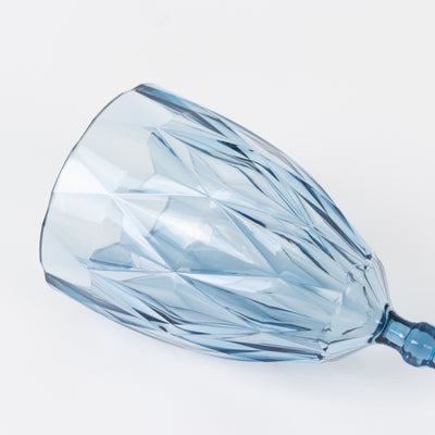 Blue crystal wine glass with a faceted design