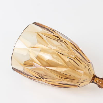 Amber crystal wine glass with a faceted design