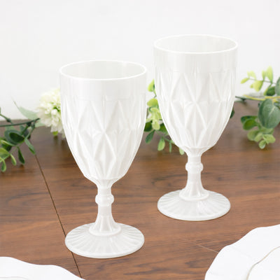 Elegant white decorative glasses on a wooden table.