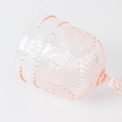 Pink decorative glass cup with intricate designs