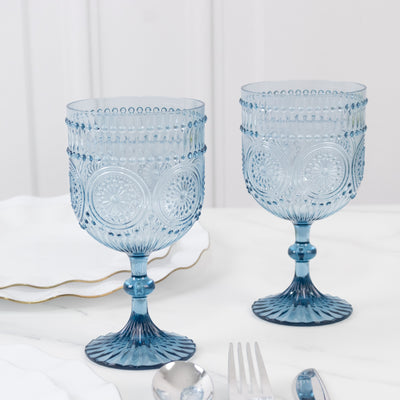 Blue decorative glass goblets on a marble table.