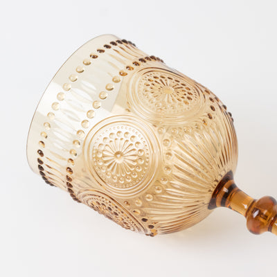 Amber decorative glass goblet with intricate pattern details