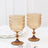 Amber vintage dessert glasses set on a marble table.