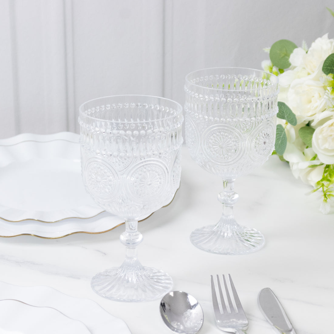 Elegant clear glass goblets with intricate patterns, perfect for dining.