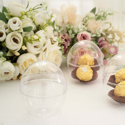 Clear plastic candy display containers with chocolate treats inside.
