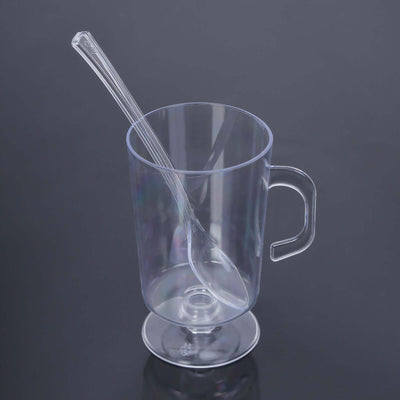 Clear plastic cup with spoon on a black background.