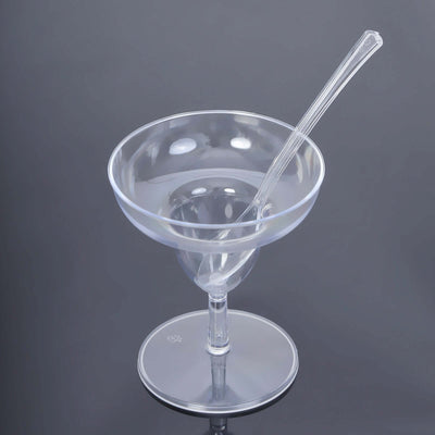 Clear plastic dessert bowl with spoon on a gray background.
