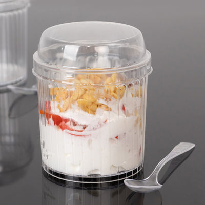 Plastic dessert cup with yogurt, strawberries, and granola. Spoon included.