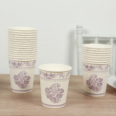 Stack of floral-patterned paper cups on a wooden table.