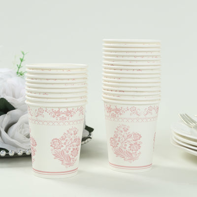 Stack of decorative pink floral paper cups on a white background.