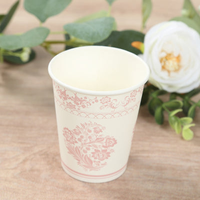 Decorative paper cup with floral design on a wooden surface.