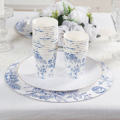 Blue floral patterned disposable cups and plates stacked on a table.