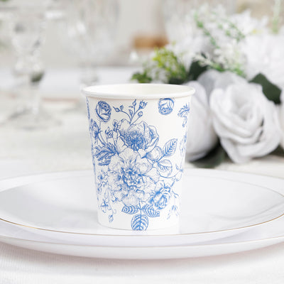 Floral-patterned paper cup on a white plate at a table setting.