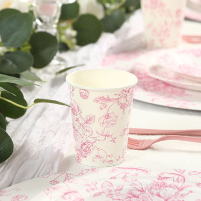 Floral patterned disposable cup on a table setting with greenery.