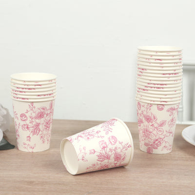 Floral design paper cups stacked on a wooden surface.