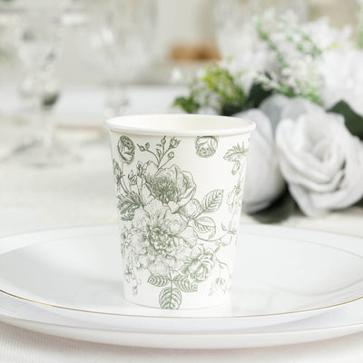Floral design paper cup on a decorative plate in a table setting.