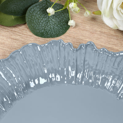 Gray decorative plate with textured rim on wooden surface.