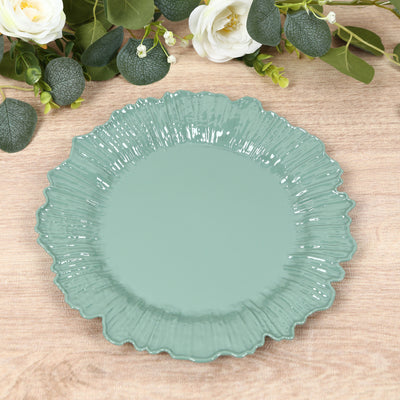 Green decorative plate with ruffled edges on wood surface.