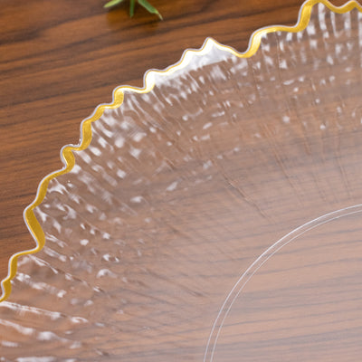 Clear decorative plate with a gold scalloped edge.