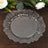 Clear glass decorative plate with a ruffled edge on a wooden surface.