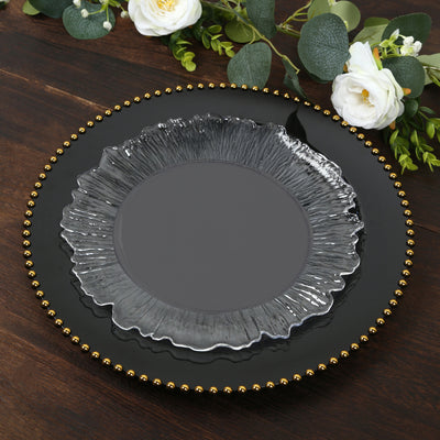 Decorative black plate with gold beading and clear glass accent.