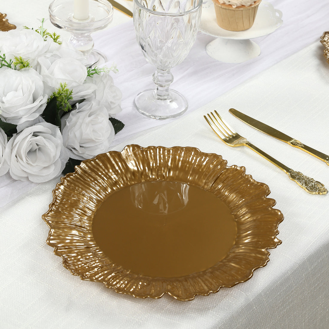Gold decorative plate with a fluted edge on a table setting.