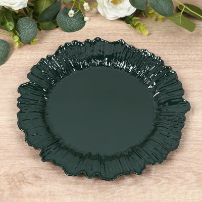 Dark green decorative plate with a fluted edge on a wooden surface.