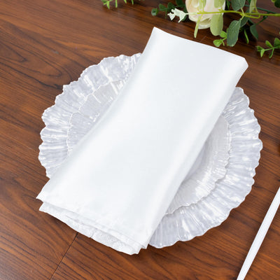 Elegant white napkin on a decorative plate.