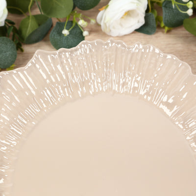 Beige decorative plate with ruffled edges on a wooden surface.
