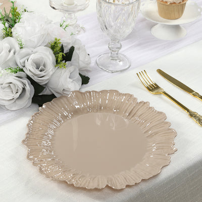 Elegant beige floral plate on a dining table with decorative elements.