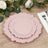 Set of three elegant pink decorative plates on a wooden table.