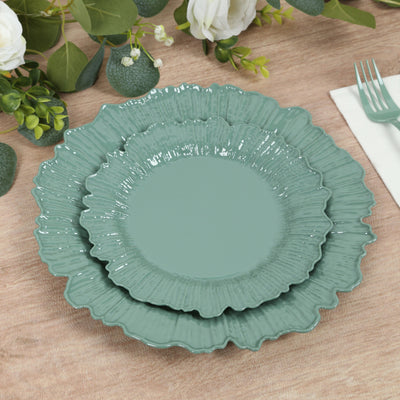 Set of three teal decorative plates with scalloped edges.