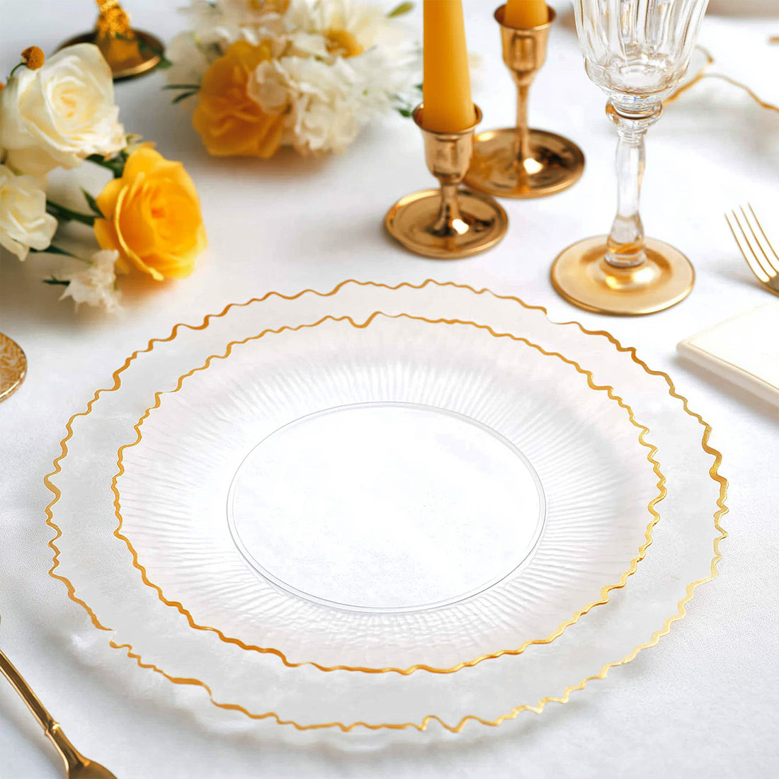 Elegant clear plates with gold trim on a festive table setting.