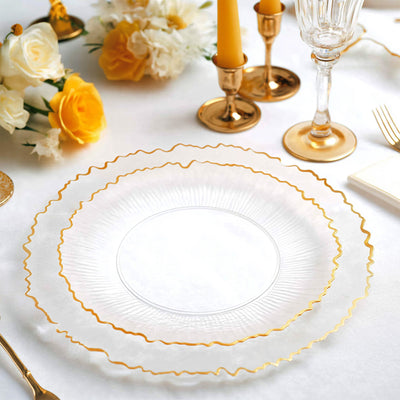 Elegant clear plates with gold trim on a festive table setting.