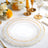 Elegant clear plates with gold trim on a festive table setting.
