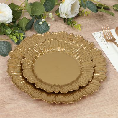 Gold decorative plates in layered design on a rustic wooden table.