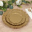 Gold decorative plates in layered design on a rustic wooden table.