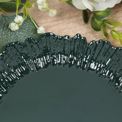 Dark green decorative plate with textured rim, surrounded by floral accents.