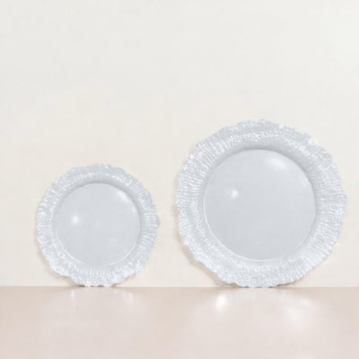 Set of two elegant white plates with scalloped edges.