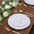 Elegant white dinner plates set on a rustic wooden table with floral decor.