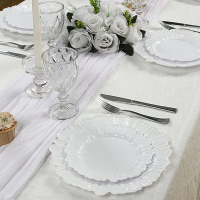 Elegant white dinner plates set on a beautifully arranged dining table.