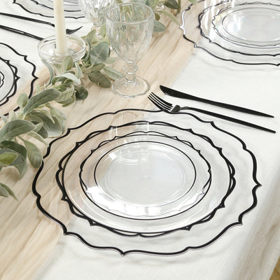 Elegant clear plates with black scalloped edges on a beautifully set table.