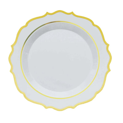 White decorative plate with gold rim on plain background