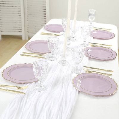 Elegant lavender dinner plates set on a white table with crystal glassware.