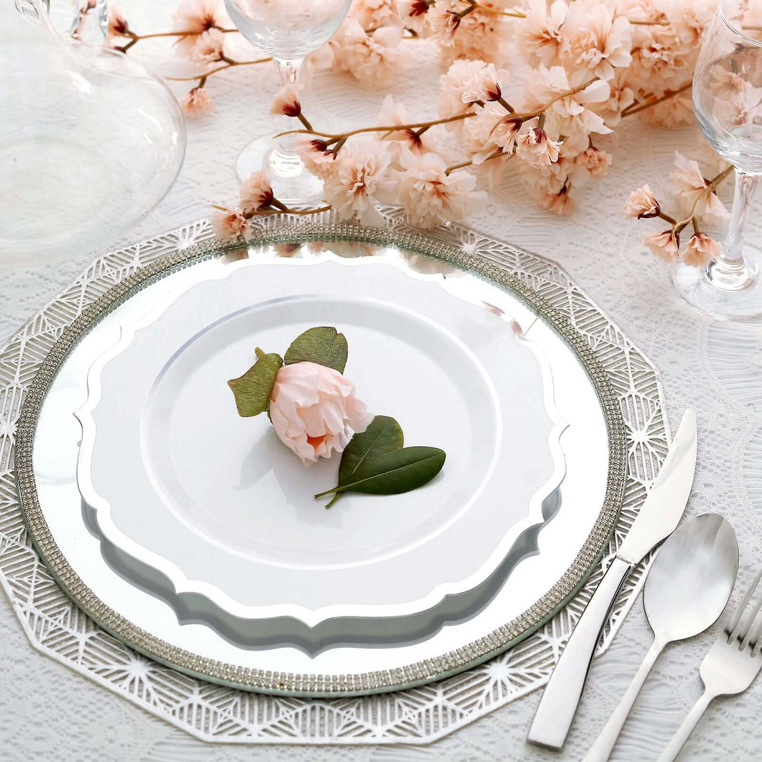 Elegant dining table setting with floral accents and decorative plates.