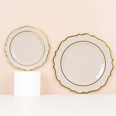 Elegant decorative plates with gold trim on a soft pink background.