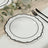Elegant white plate with black rim on a textured table setting.
